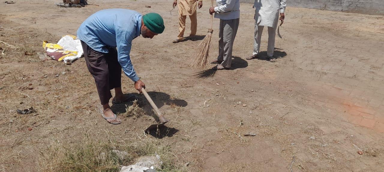 Farmers weighing grain — the harvest a microloan helps fund